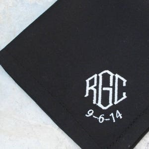 May include: Black cotton handkerchief with white embroidered initials "RGC" and the date "9-6-14".