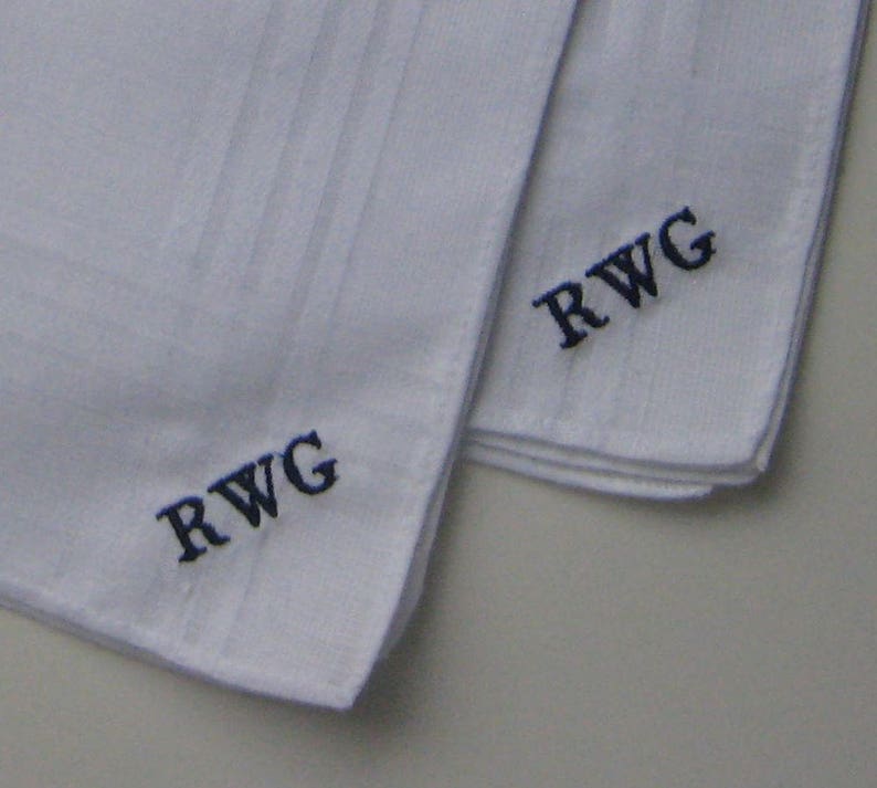 May include: Two white handkerchiefs with blue embroidered initials "RWG" on each.