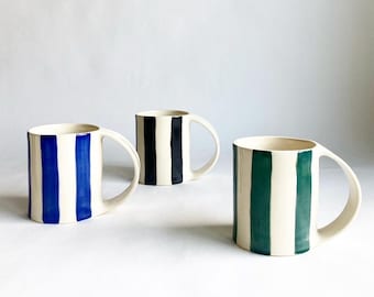 Large ceramic coffee mug with hand painted stripes in blue, red, green, black