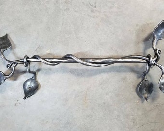 Wrought iron leaf and vine towel bar.