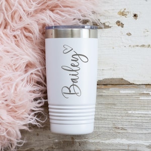 May include: White stainless steel tumbler with a heart and the name "Bailey" engraved on it.