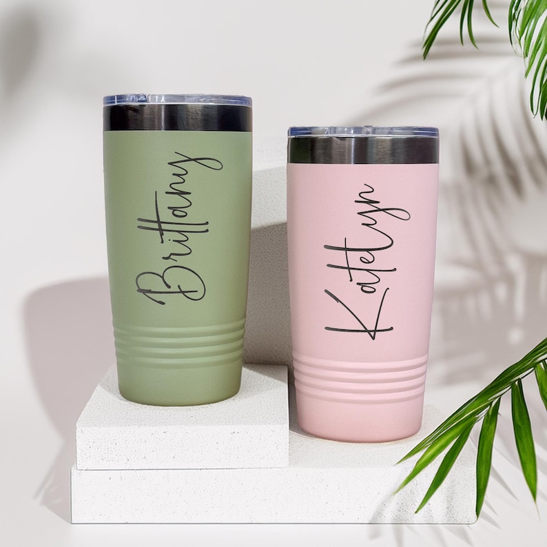 May include: Two personalized stainless steel tumblers, one green with the name "Brittany" and one pink with the name "Katelyn".