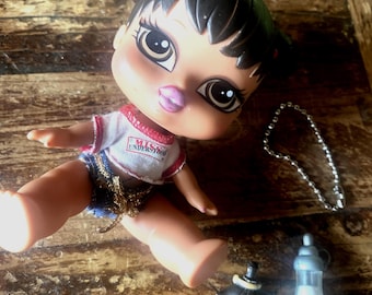 Vintage Bratz Babyz Jade from 2004, wearing a crop top with s MISS UNDERSTOOD graphic and a baby bottle.