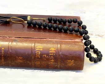 Vintage bohemian long  black braided leather black lava and gold beaded necklace. Two gold loops and small gold beads.