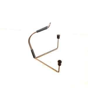 May include: A metal display stand constructed from thin, dark-toned wire. The frame features two upright supports topped with small black rubber caps and a curved back support arm wrapped in black textured material for stability and grip.