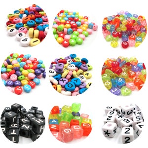 May include: Assortment of colorful plastic alphabet and number beads. The beads are in various shapes, including circles, hearts, and squares. Some beads are translucent, while others are opaque. The beads are perfect for crafting jewelry, making keychains, or adding a touch of whimsy to any project.
