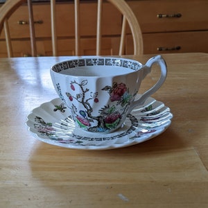 Vintage Staffordshire teacup and saucer in Indian Tree pattern; cup 2 1/2 inches high and saucer 5 3/4 inches in diameter.
