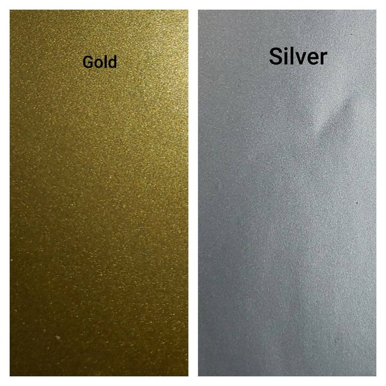 May include: Two swatches of metallic paint, one gold and one silver. The swatches are side-by-side and show the texture of the paint.