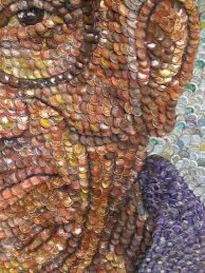 May include: A close-up of a mosaic portrait made from bottle caps. The portrait is of a person with brown hair and a beard. The bottle caps are arranged in a pattern to create the image.