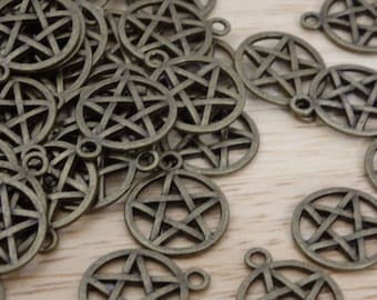 May include: A pile of antique bronze-colored metal charms in the shape of a five-pointed star. The charms have a loop at the top for attaching to jewelry or other crafts.