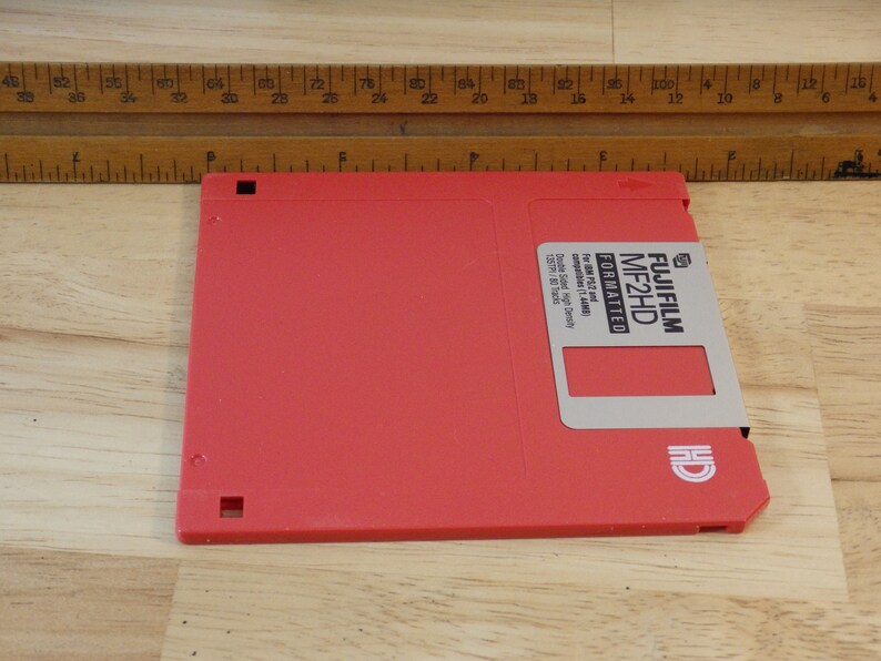 May include: A red 3.5 inch floppy disk labeled "FUJIFILM MF2HD FORMATTED" for IBM PC/3.5 and "Double Sided High Density 1.44MB 122TPI 80 Tracks".