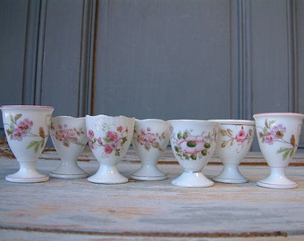 Set of 7 antique french mismatched porcelain egg cups with pink flowers. Paris porcelain. Mismatched dishes. Shabby chic serving.