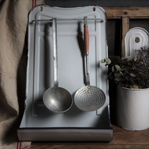 Antique french white enamel utensil rack with metal utensils and extra utensil holder. White kitchen enamelware set. Rustic kitchen decor