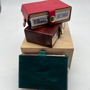 Leather bound three snap travel cribbage board.