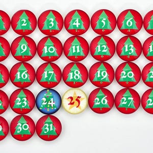 May include: A red and green Christmas advent calendar with 31 numbered circles. Each circle features a green Christmas tree with a white number on it. The 25th circle is a yellow star.