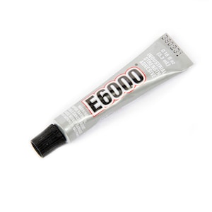 May include: A silver tube of E6000 industrial strength adhesive with a black cap. The tube is labeled with the product name, size, and warnings.