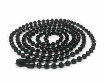 May include: A black metal chain with a ball link design. The chain is coiled and has a clasp at one end.