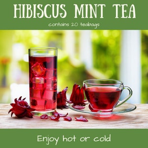 May include: A glass of iced hibiscus mint tea with ice cubes and a cup of hot hibiscus mint tea. The tea is a vibrant red color and is surrounded by dried hibiscus flowers. The text "Hibiscus Mint Tea" and "contains 20 teabags" is at the top of the image. The text "Enjoy hot or cold" is at the bottom of the image.