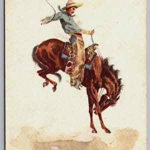 Antique cowboy postcard illustration of a bronco rider mid-buck from “In the Saddle.” Western horse art with retro colors, perfect for ranch-style décor, farmhouse walls, boys’ rooms, or vintage Americana collectors. Rustic Western artwork reproduction for home or cabin