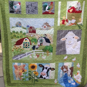 May include: A green patchwork quilt with a farm theme. The quilt features a variety of farm animals, including chickens, pigs, cows, and a sheep. There are also barns, sunflowers, and a red wagon. The quilt is made with a variety of fabrics and textures, and it is quilted with a simple stitch.