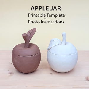 May include: Two apple-shaped jars, one brown and one white, with lids and stems. The brown jar has a leaf-shaped stem, while the white jar has a stem with a leaf. The text "APPLE JAR Printable Template + Photo Instructions" is at the top.