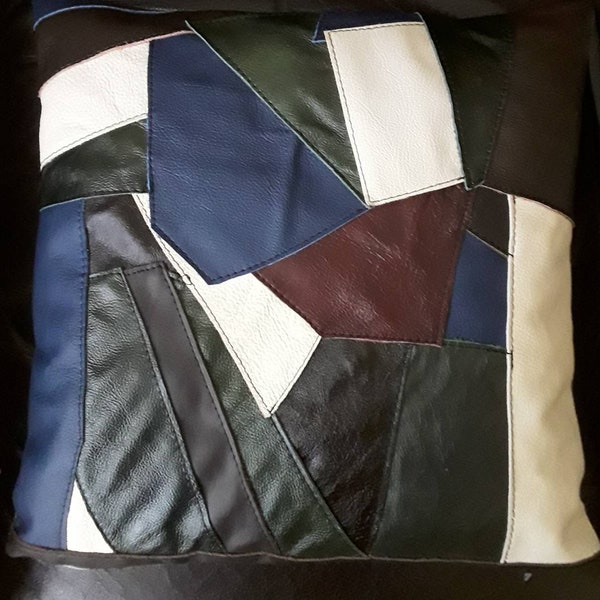 Real leather patchwork cushion cover, with grey linen and zip opening. Blue, green, burgundy, cream and brown. 16" x 16"