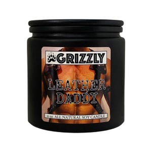 May include: Black candle jar with a label that says "Grizzly Leather Daddy" and "11 oz. All Natural Soy Candle".