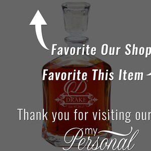 May include: A clear glass decanter filled with amber liquid, featuring a square stopper and an etched design with the letter D, the name DRAKE, and the text Est. 07.29.17. The image includes white text overlays: Favorite Our Shop, Favorite This Item, Thank you for visiting our, and my Personal.