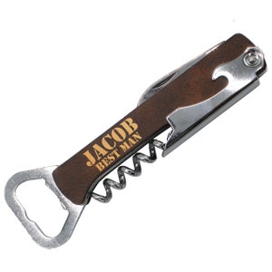 Op de afbeelding: Een multitool met een bruin houten handvat, voorzien van een kurkentrekker, een flesopener en een mes. Het handvat is gegraveerd met de tekst "Jacob Best Man".