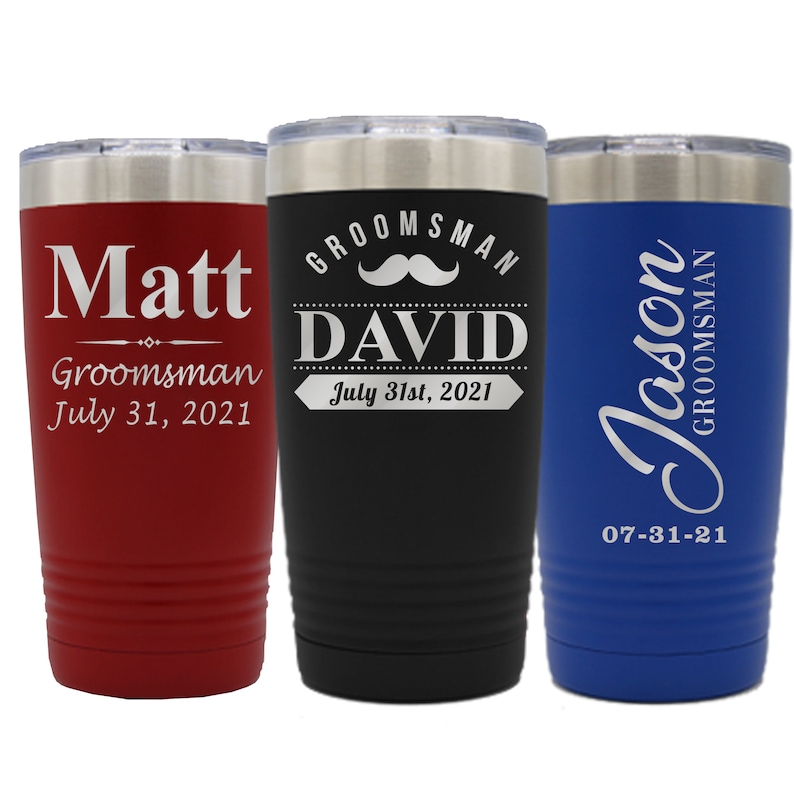 May include: Three stainless steel tumblers with personalized engravings. The red tumbler says "Matt Groomsman July 31, 2021". The black tumbler says "Groomsman David July 31st, 2021" with a mustache graphic. The blue tumbler says "Jason Groomsman 07-31-21".