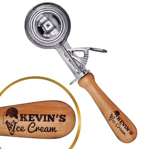 May include: A silver ice cream scoop with a wooden handle. The handle is engraved with the text "KEVIN'S Ice Cream" and a small ice cream cone graphic.