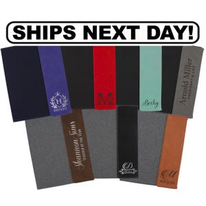 May include: A collection of rectangular, vertical bookmarks in various colors including navy, purple, black, red, teal, gray, brown, and tan. Each bookmark features personalized laser-engraved text or monograms such as Henry, Miller, Becky, Arnold Miller, Shannon Sims, Drake, and Mason.