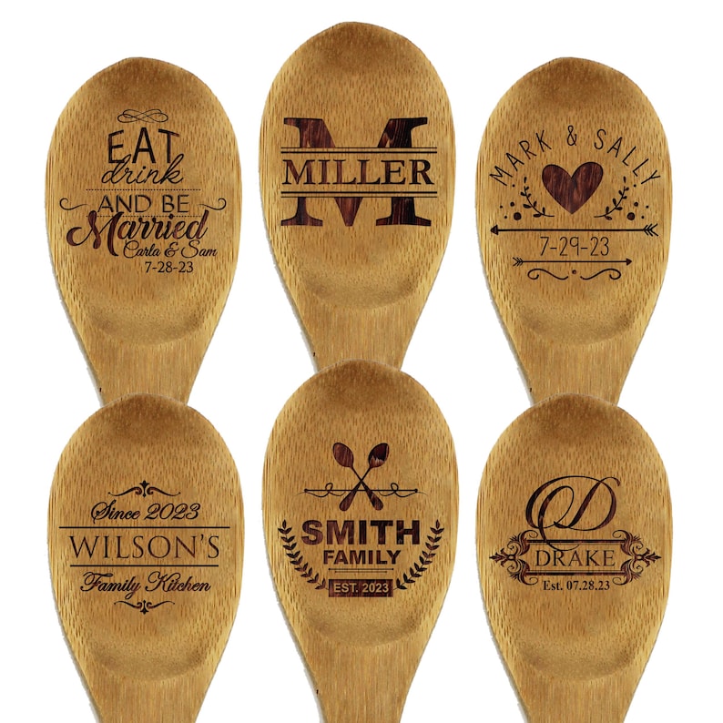 May include: Six wooden spoons with engraved designs. One spoon reads "Eat, drink, and be Married" with a date. Another features "Miller" and a large letter "M". Other spoons display "Mark & Sally" with a heart, "Wilson's Family Kitchen", "Smith Family", and "Drake".