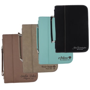 May include: Four leather Bible covers in brown, tan, teal, and black. Each cover has a handle, a zipper, and personalized text. The brown cover reads "Landon Baker, Philippians 4:13." The teal cover reads "Trevor Smith, Psalm 28:7." The black cover reads "John Washington, Reverend."