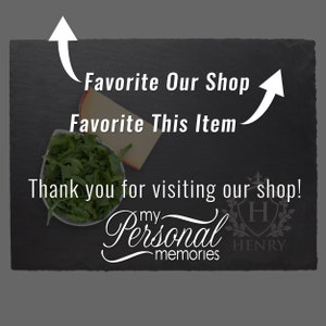 May include: A rectangular black slate board featuring white text that reads Favorite Our Shop, Favorite This Item, Thank you for visiting our shop!, and My Personal Memories. A small white bowl of green arugula and a slice of cheese are visible.