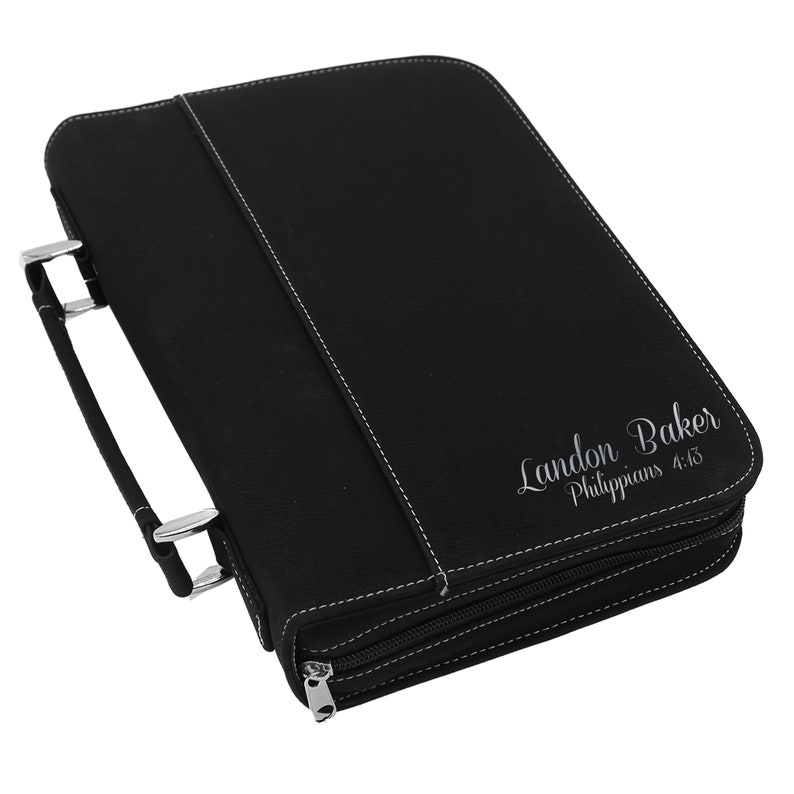 May include: Black leather Bible cover with white stitching and a silver zipper. The cover has a handle and the name "Landon Baker" and "Philippians 4:13" printed on the front.
