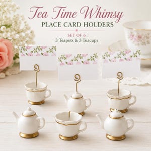May include: A set of six place card holders featuring three miniature white ceramic teapots and three white ceramic teacups with gold rims. Each piece has a gold wire spiral top to hold a white card with a pink floral border. Text reads Tea Time Whimsy.