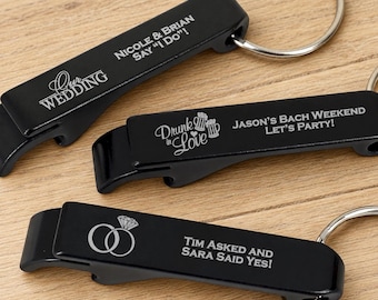 May include: Three black metal bottle opener keychains with silver engraved text and graphics. One reads "Our Wedding" and "Nicole & Brian Say 'I Do'!", another "Drunk in Love" with beer mugs, and the third shows rings with "Tim Asked and Sara Said Yes!"
