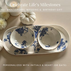 May include: A white ceramic serving tray with two matching bowls, featuring a blue floral design and gold trim. The tray and bowls are personalized with initials and a heart. Text on the image reads "Celebrate Life's Milestones" and "Anniversary, Wedding & Birthday Gift."