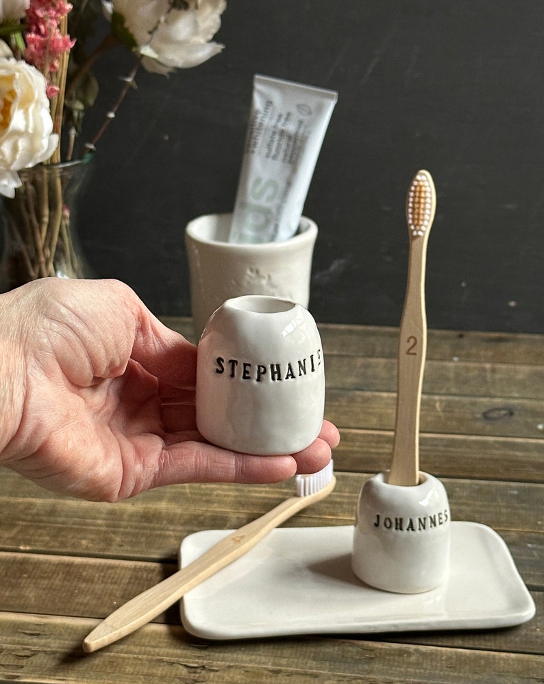individual ceramic toothbrush holder with personalized name engraved and glazed in black, shiny white toothbrush holder
