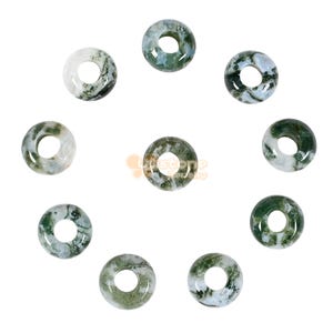 May include: Nine moss agate donut beads are displayed. Each bead is a ring shape with a central hole. The colours are white, green, and grey, with a marbled pattern. These beads are suitable for jewellery making.