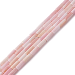 May include: A strand of pink and white shell beads, each bead is a rectangular tube shape.