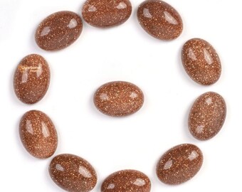 Puede incluir: Un círculo de doce piedras ovaladas de color marrón con una textura brillante.