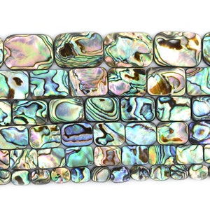 May include: A strand of iridescent abalone shell beads in a rectangular shape. The beads have a variety of colors, including green, blue, purple, and gold.
