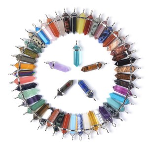 May include: A collection of 30 colorful crystal point pendants with silver caps. The pendants are arranged in a circle with the points facing outwards. The crystals are of various colors, including red, orange, yellow, green, blue, purple, and brown.