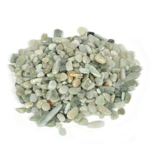 May include: A pile of light green jade stones, some are smooth and round, others are more elongated and flat.