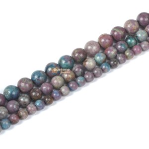May include: A strand of round, multi-colored gemstone beads. The beads are a mix of purple, blue, and green with a speckled, mottled appearance.