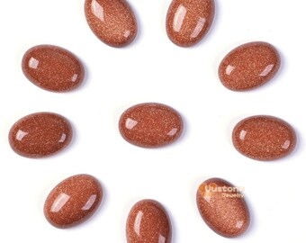Puede incluir: Diez cabujones de arenisca de color marrón rojizo lisos y ovalados. Las piedras están dispuestas en círculo sobre un fondo blanco.