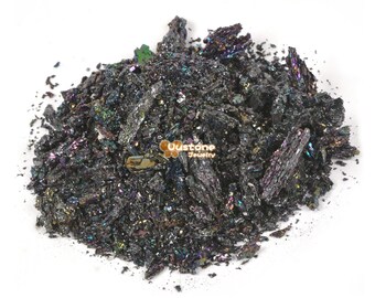 May include: A pile of iridescent black silicon carbide crystals. The crystals are sharp and have a metallic sheen.