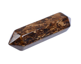 May include: A brown and gold crystal point, also known as a wand or a scepter, is a polished piece of natural stone. It has a pointed end and a flat base. The crystal is a dark brown colour with gold flecks throughout.